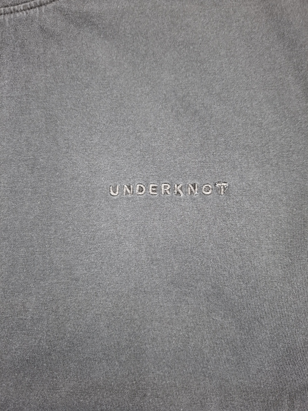 Wordmark embroidery on an UNDERKNOT physical sample, received September 6